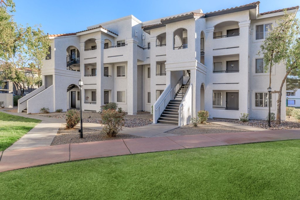 a large white building with a staircase in front of it