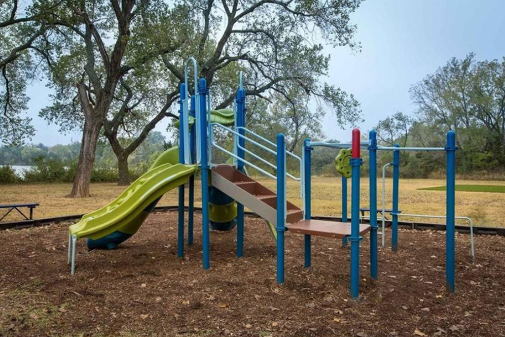 a playground with a slide in a park
