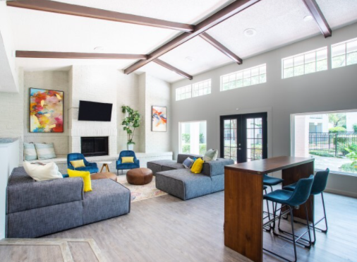 a large open living room with a fireplace and a tv on the wall