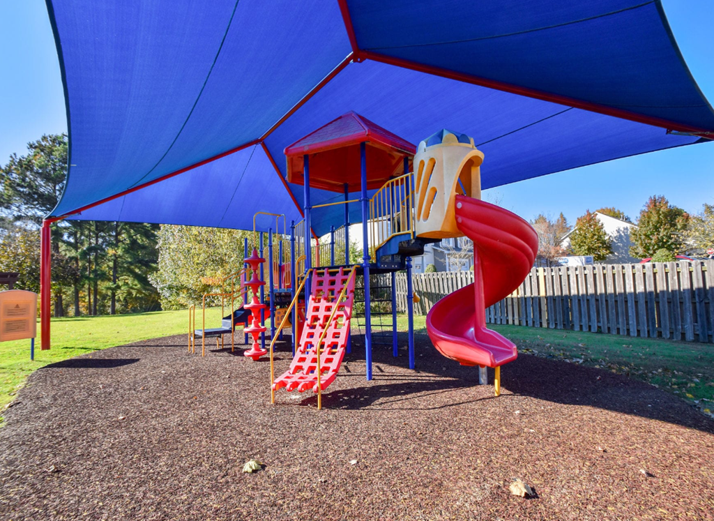 a playground with a swing set and slides