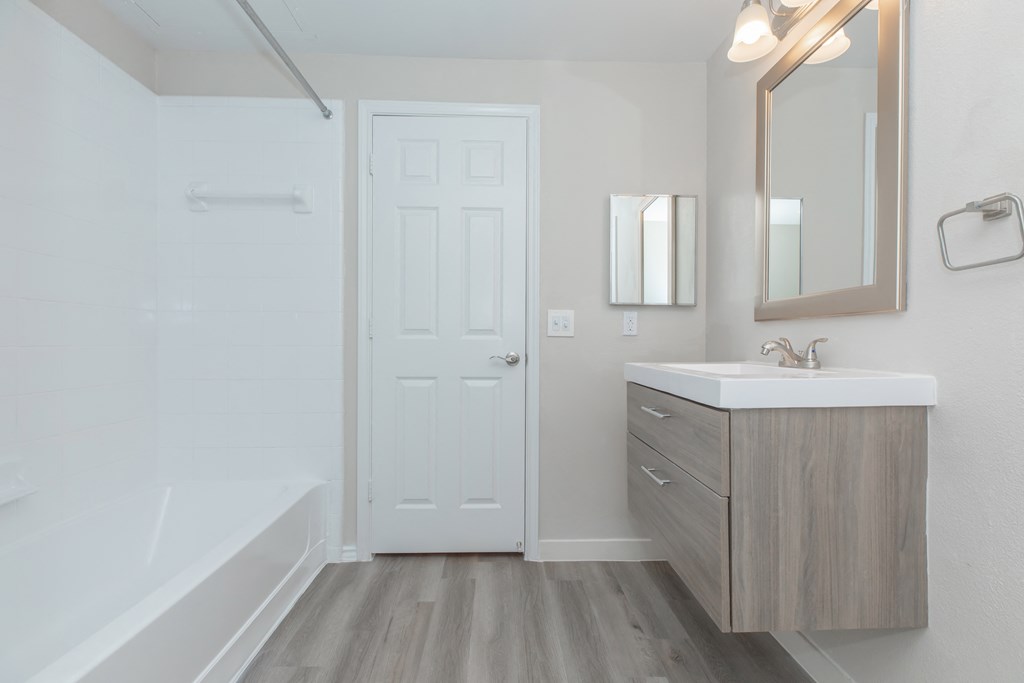 a bathroom with a sink and bathtub in a 555 waverly unit