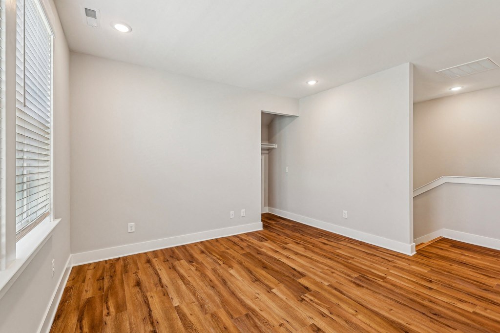 A room with wooden floors and white walls.