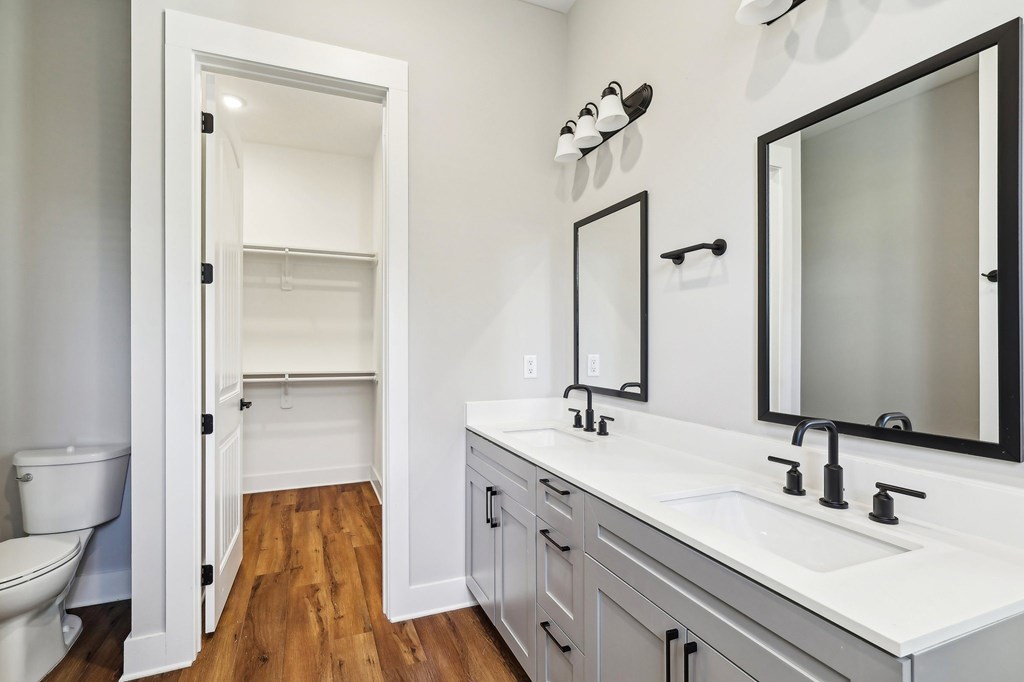 A white bathroom with a toilet and sink.