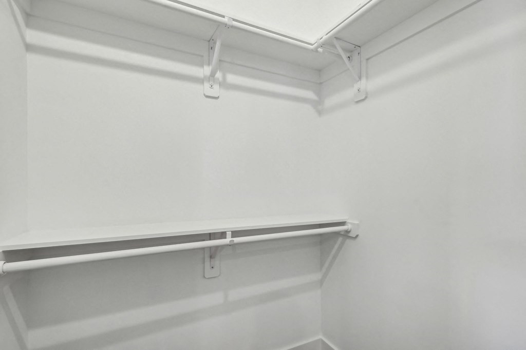 Empty white shelves in a room.