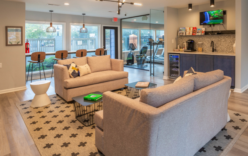 a living room filled with furniture and a flat screen tv