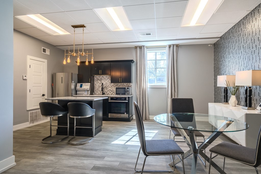 a dining room and kitchen with a glass table and chairs