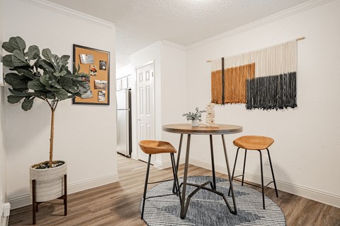 a living room with two stools and a small table