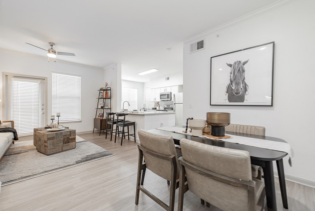 a living room and dining room with a table and chairs