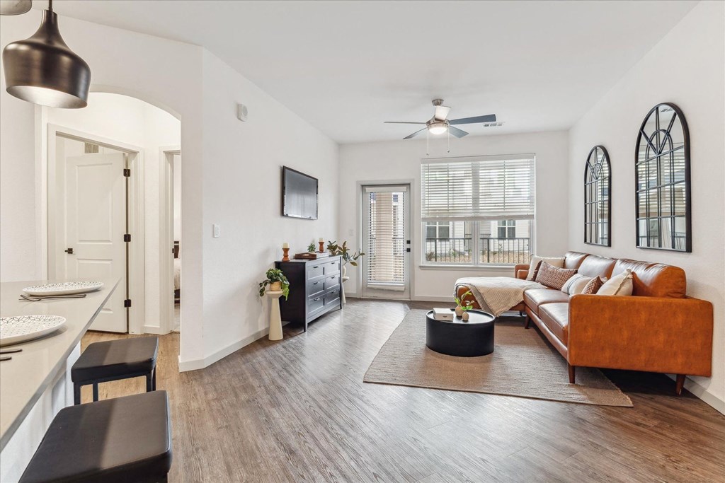 a living room with a couch and a ceiling fan