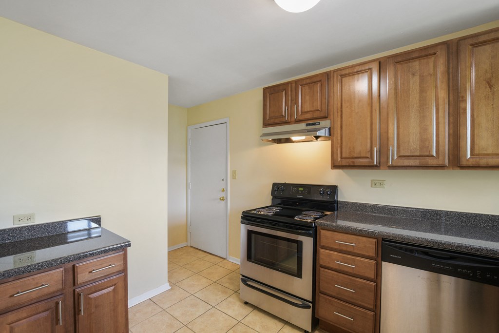 Spacious kitchen with stainless steel appliances and wood cabinets