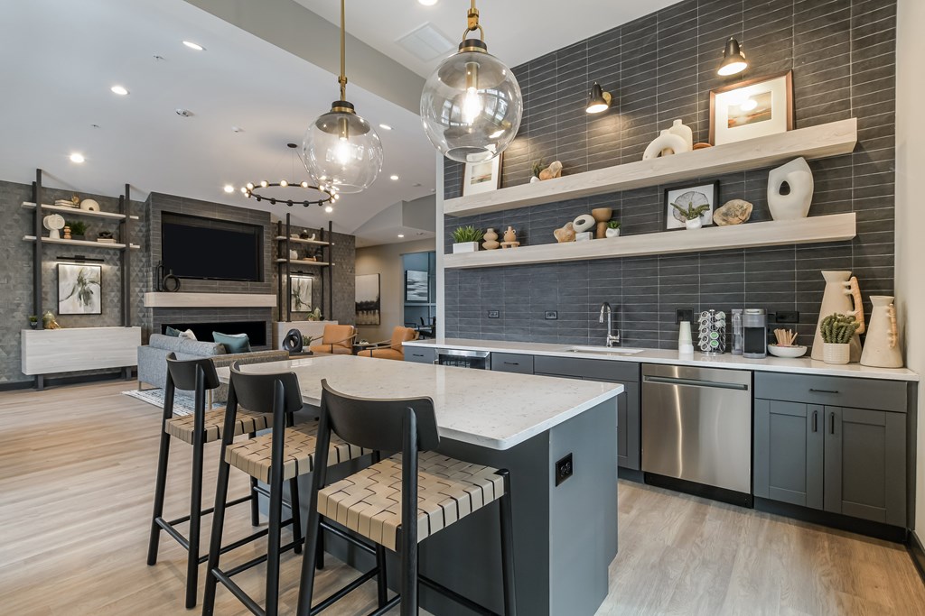 A modern kitchen with a bar area and a dining table.