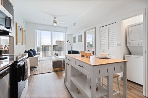 A kitchen with a table and chairs in the middle of the room.
