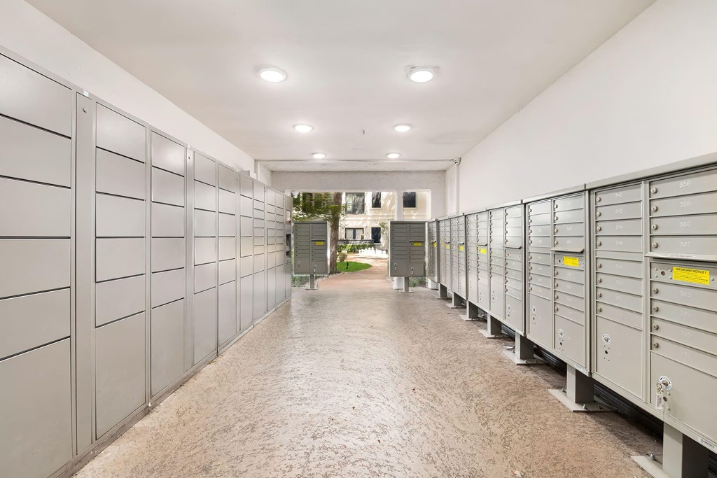 a row of lockers in a hallway with a building in the background