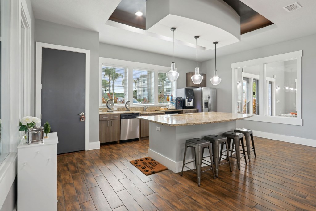 A kitchen with a large island and bar stools.