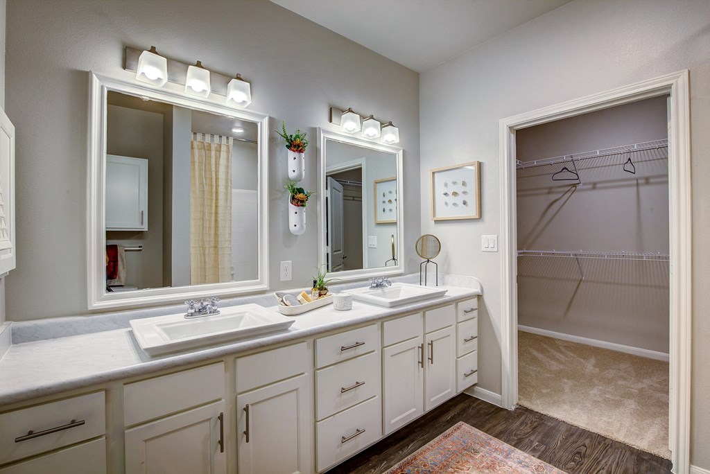 a bathroom with a large mirror and two sinks