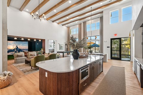 A modern kitchen with a large island and wooden floors.