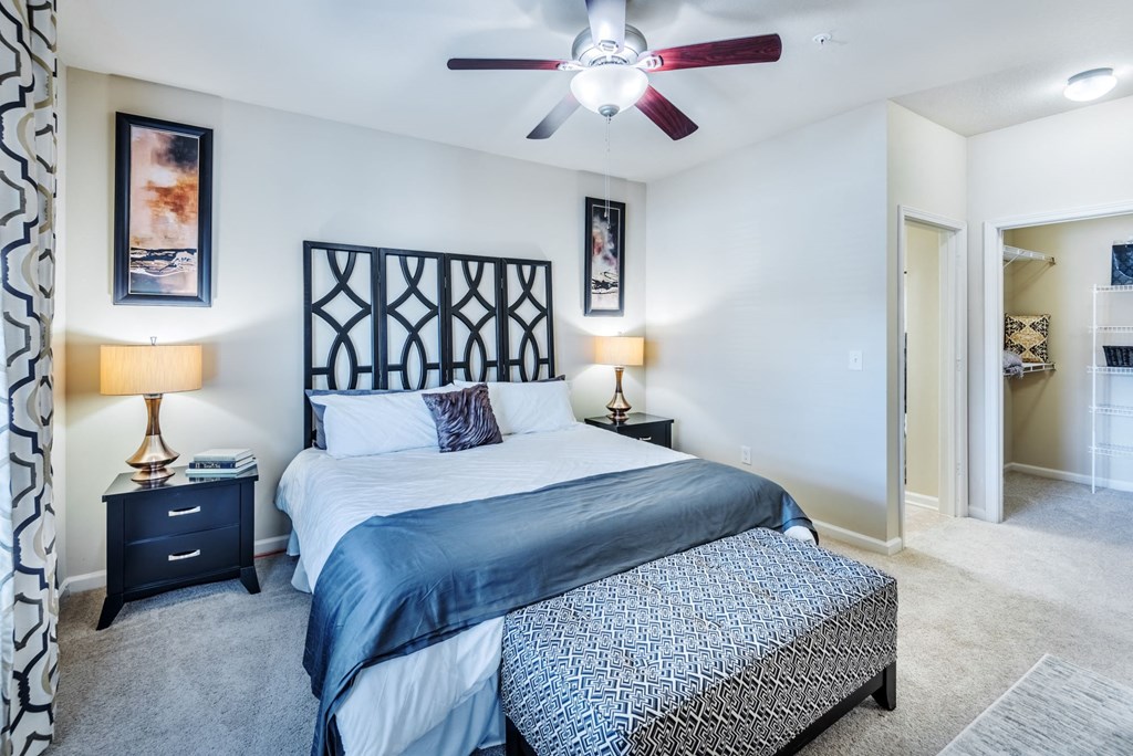 a bedroom with a bed and a ceiling fan