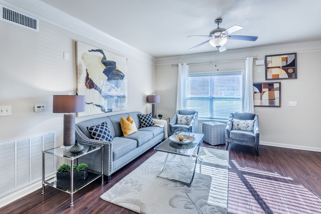 a living room with a couch and a ceiling fan