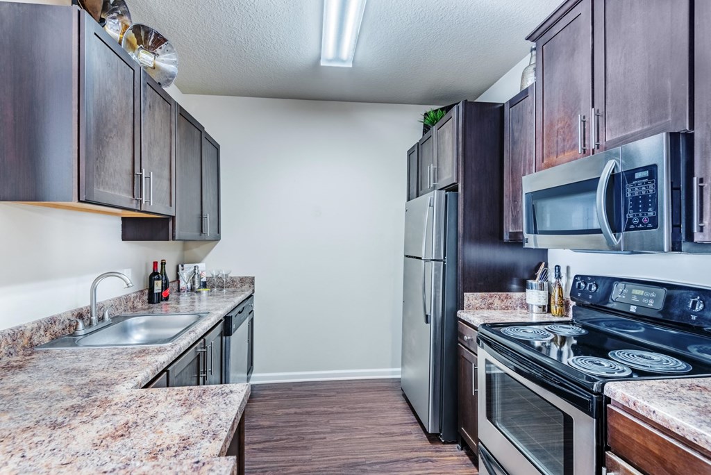 a kitchen with stainless steel appliances and marble counter tops