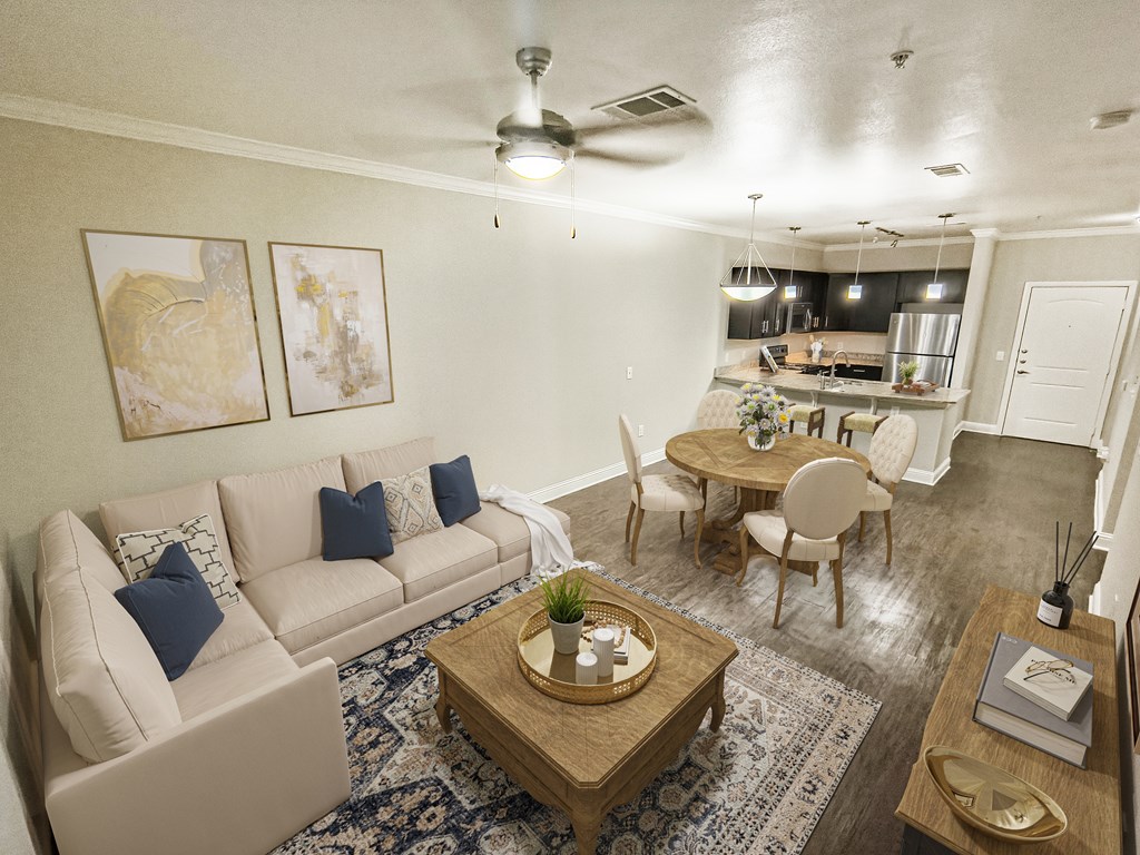 A living room with a beige couch, a wooden coffee table, and a ceiling fan.