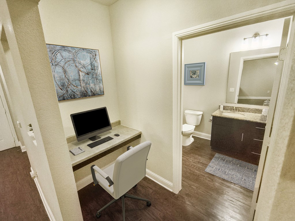 A room with a desk and a chair.