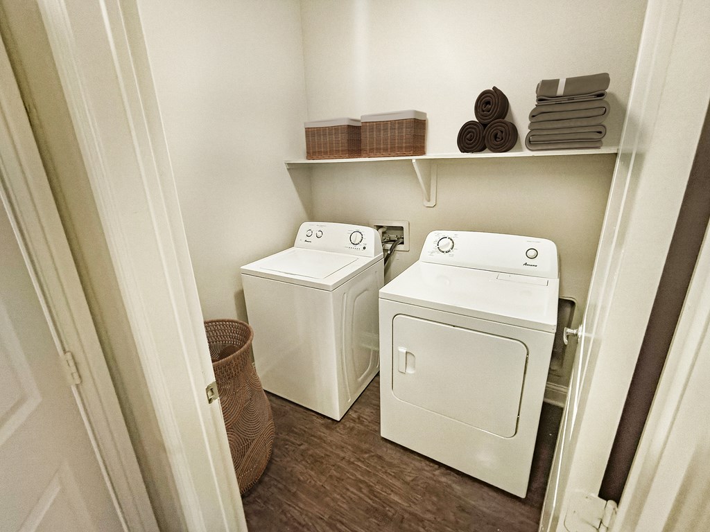 A small laundry room with a washer and dryer.