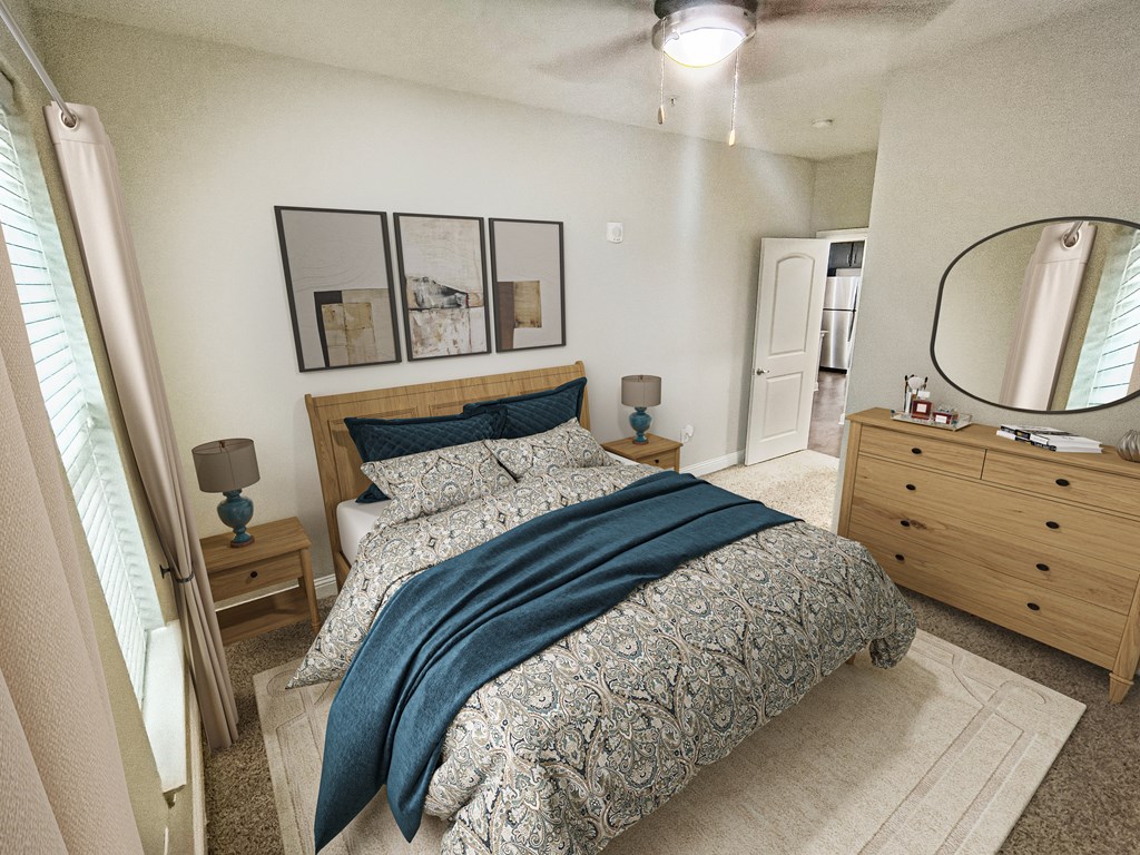 A bedroom with a bed, nightstand, and a dresser with a mirror.