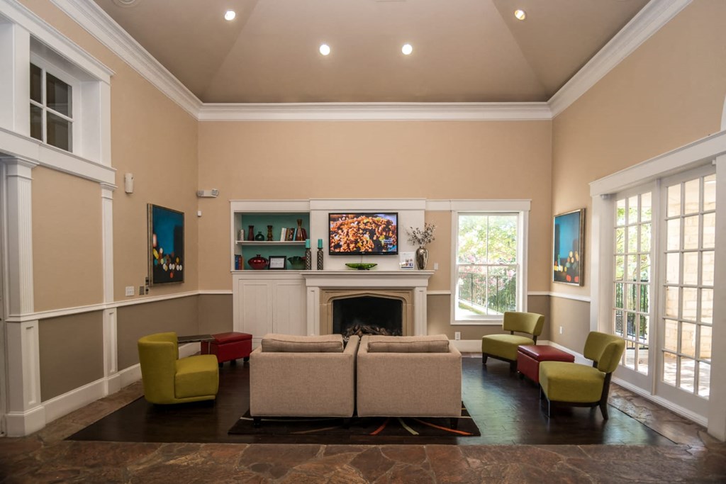 a living room with couches and chairs and a fireplace