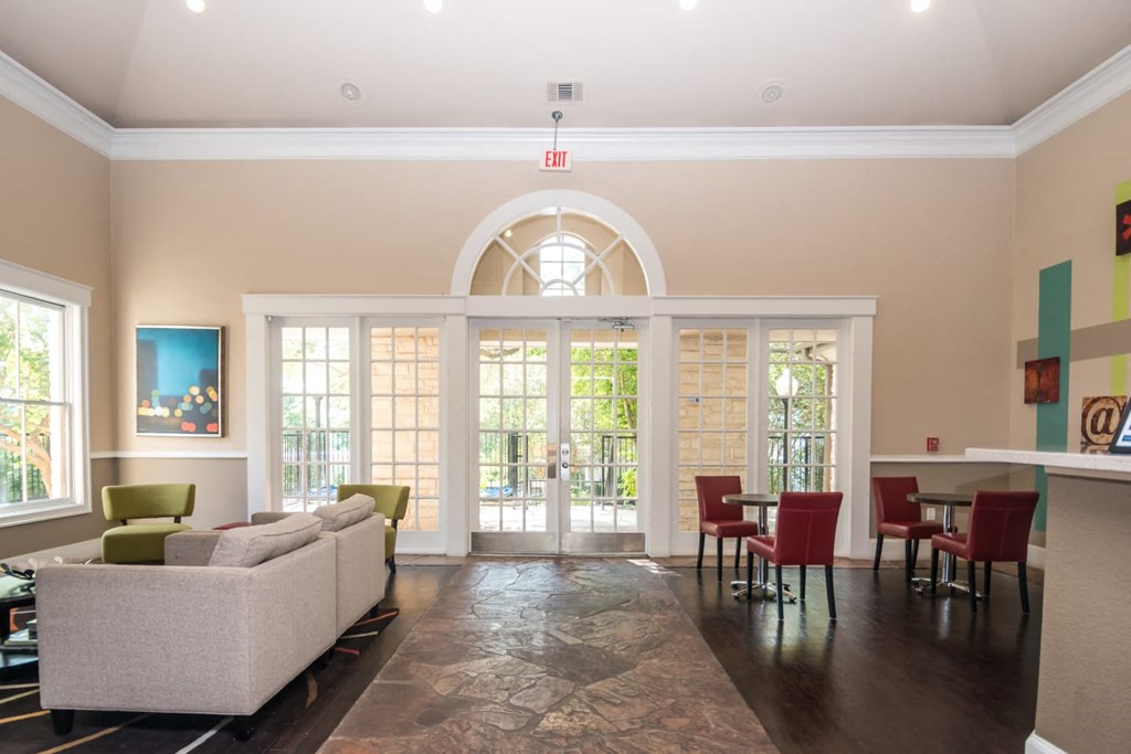a living room with a couch and a table with chairs