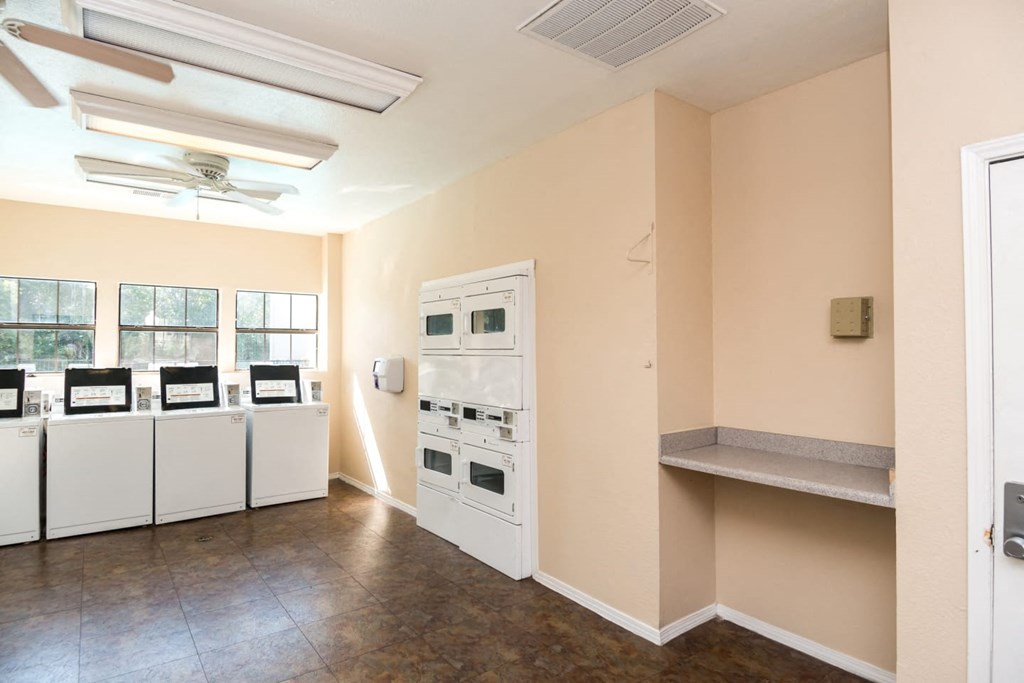 a kitchen with appliances and a counter in a room