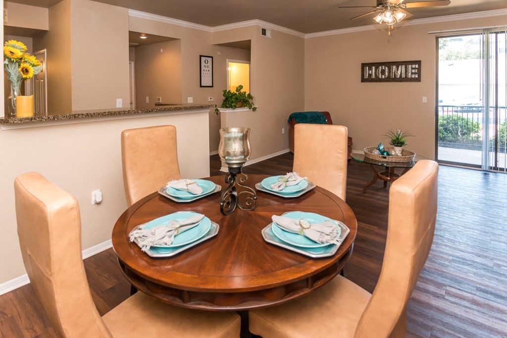 a dining room with a wooden table and chairs