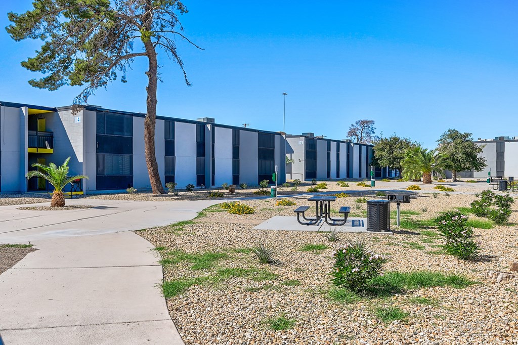 a courtyard with a picnic table in front of a building