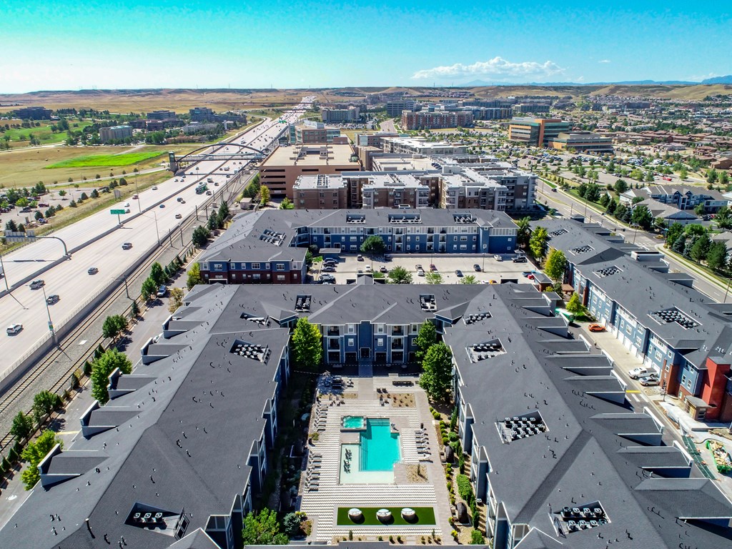 an aerial view of a city with buildings and a pool
