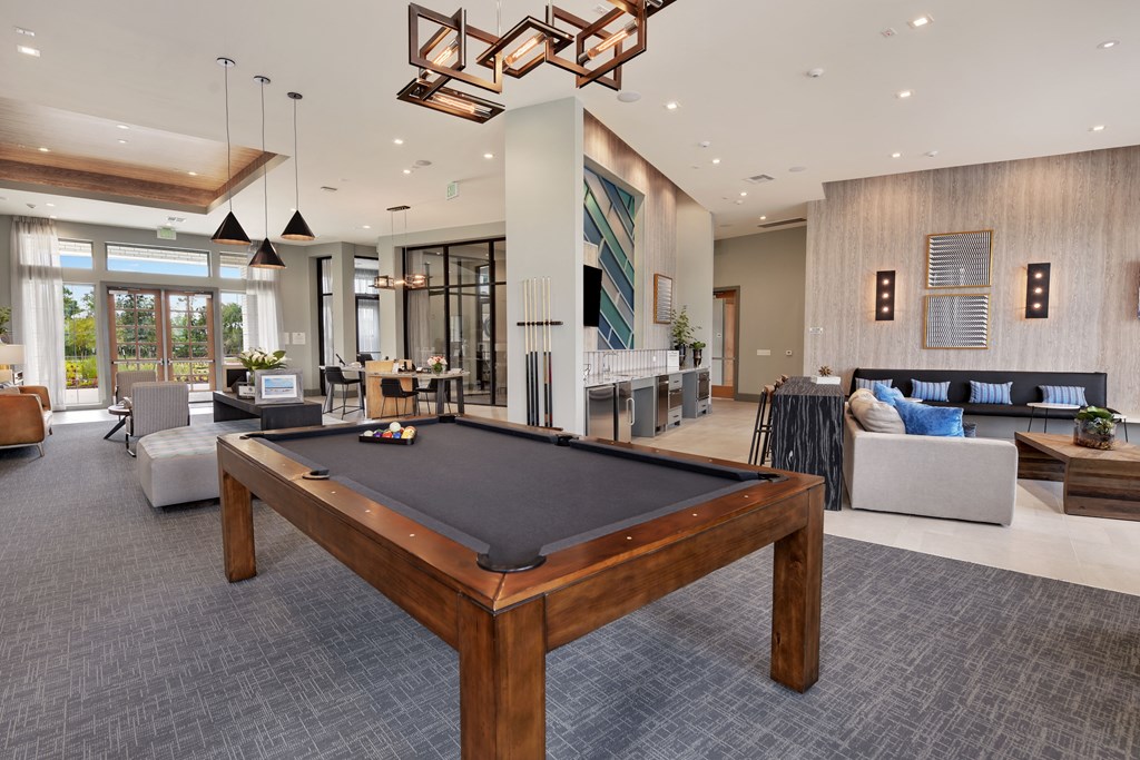 a clubhouse with a pool table in the middle