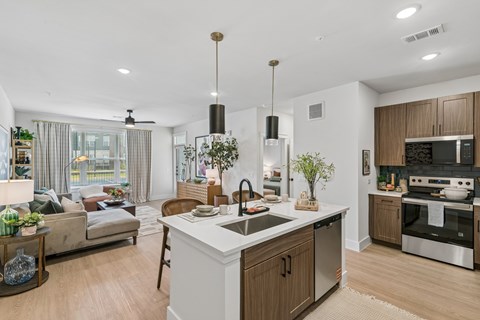 A modern kitchen with a large island and wooden cabinets.