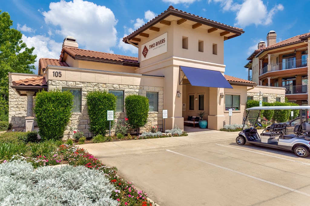a golf cart parked in front of a hotel building