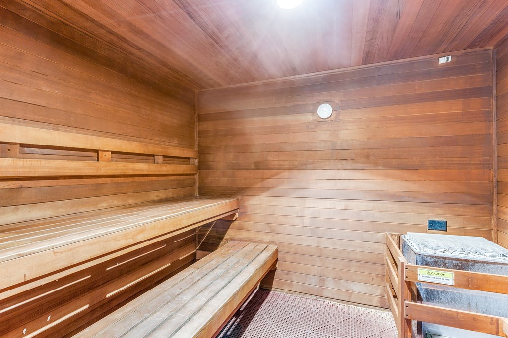 a sauna with wooden benches and a table