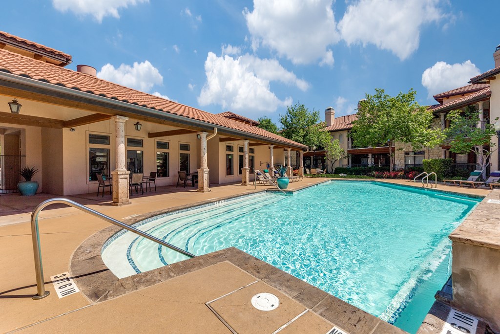 a swimming pool with a house in the background