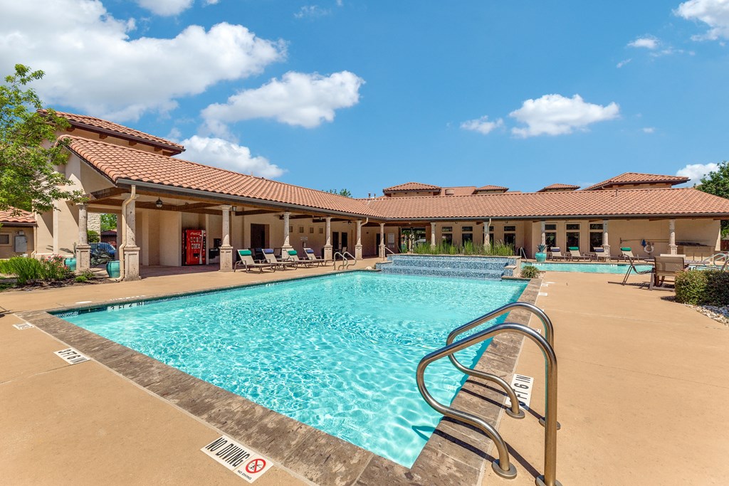 a swimming pool with a building in the background