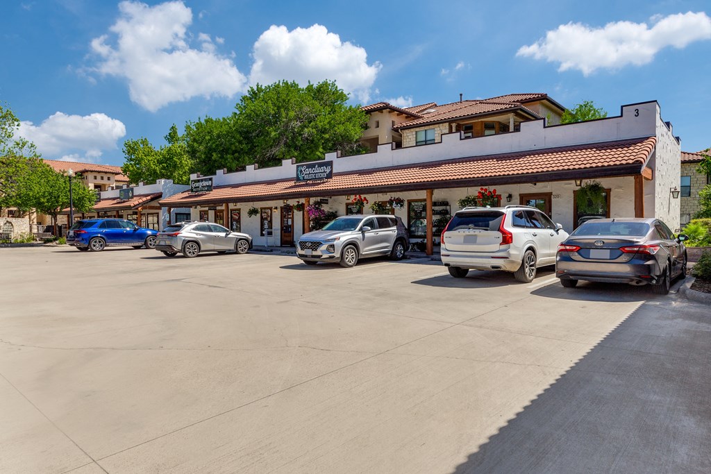 a parking lot with cars parked in front of a restaurant