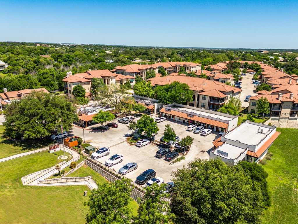 an aerial view of a parking lot and buildings in a city