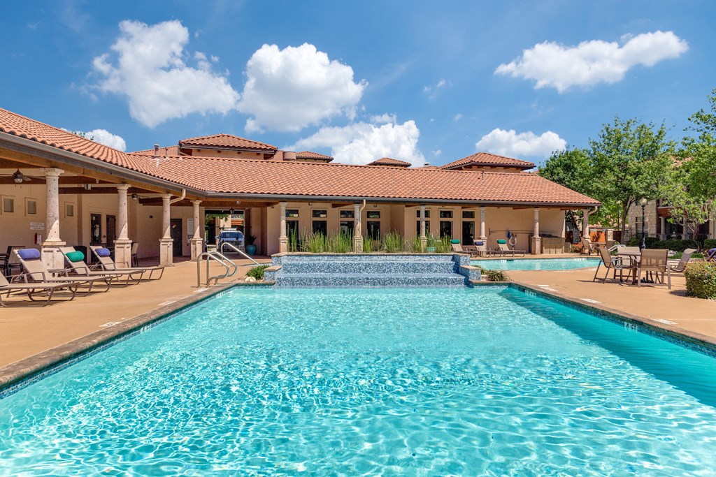 a swimming pool with a house in the background