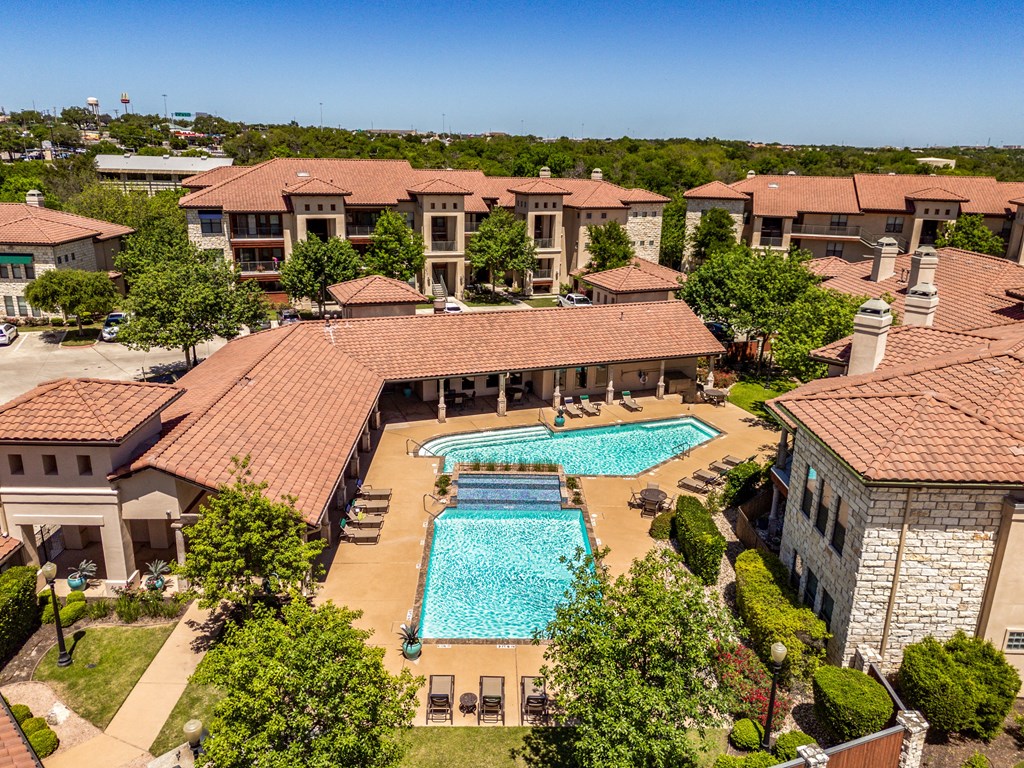 an aerial view of the pool at the resort on a sunny day