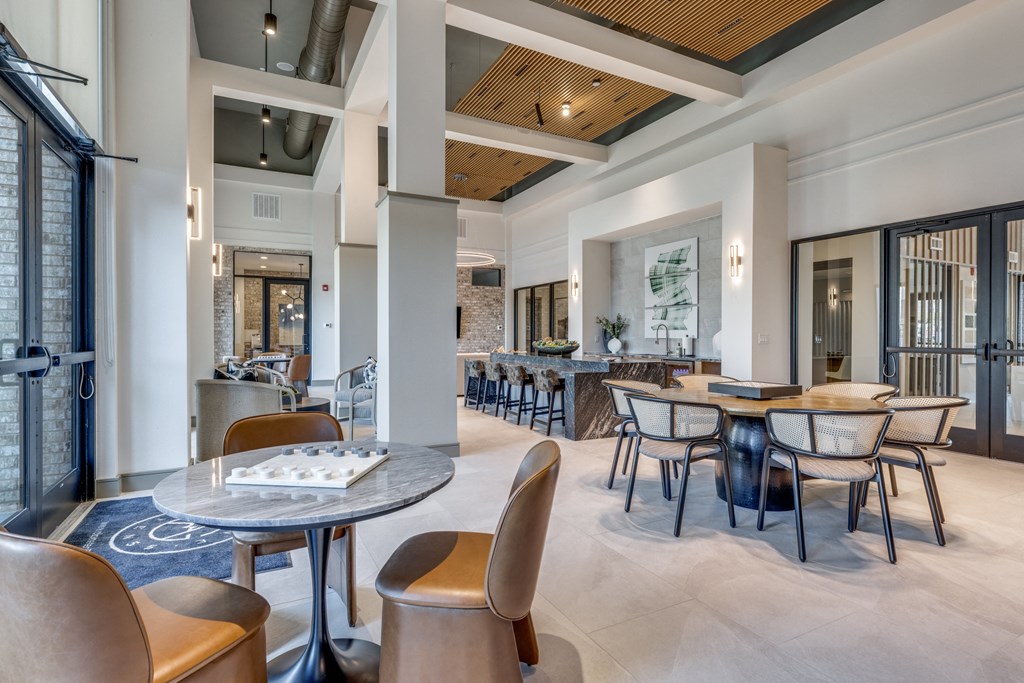 the lobby of a restaurant with tables and chairs