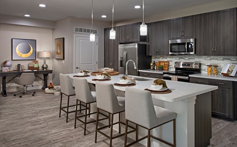 A modern kitchen with a dining table set for four.