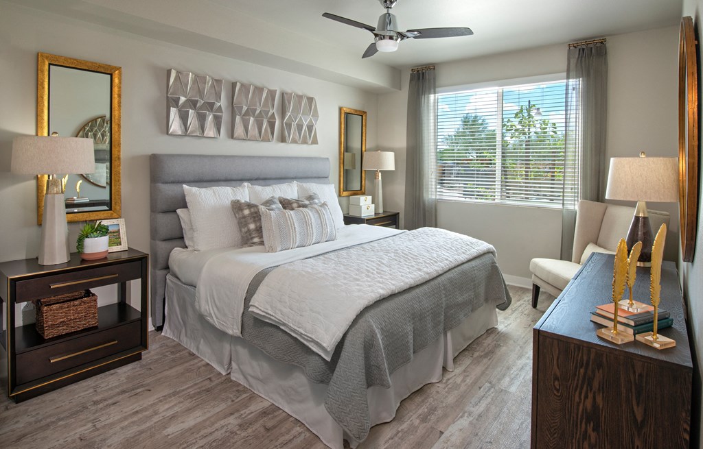 a bedroom with a large bed and a ceiling fan