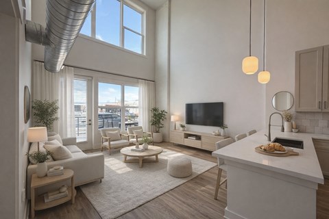 A modern living room with a large window, a white sofa, a coffee table, and a kitchen area with a countertop and a sink.