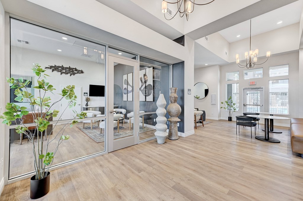 a living room with glass sliding doors and a wood floor
