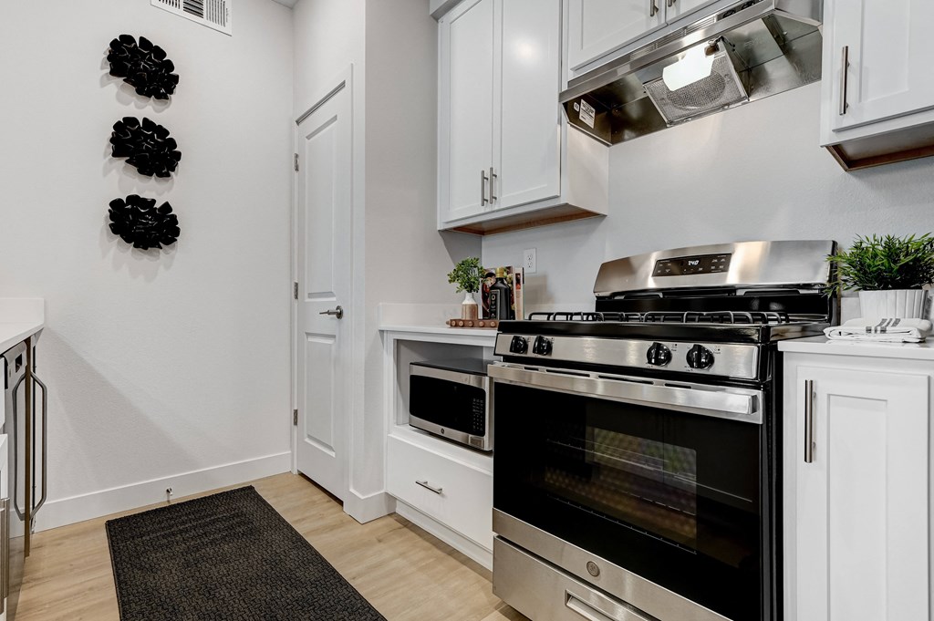 a kitchen with stainless steel appliances and white cabinets