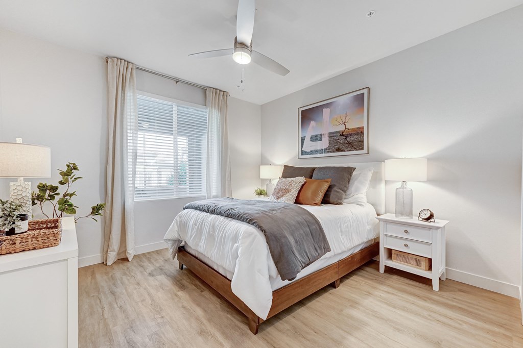 a bedroom with a bed and a ceiling fan